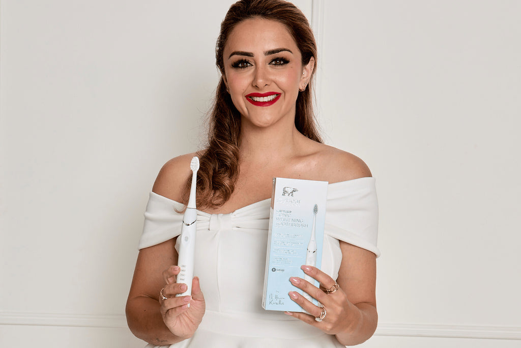 Hanna holding next generation electric toothbrush